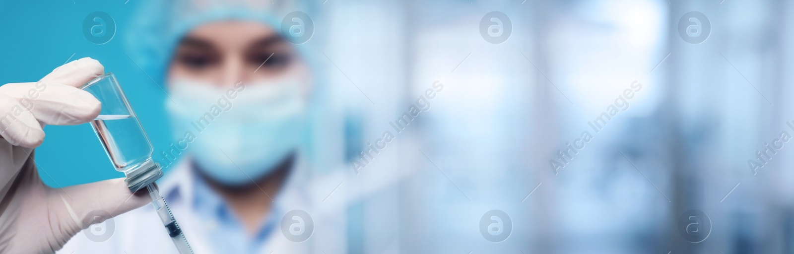 Image of Doctor filling syringe with medication from glass vial on blurred background, closeup. Banner design