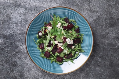 Photo of Fresh delicious beet salad on grey table, top view