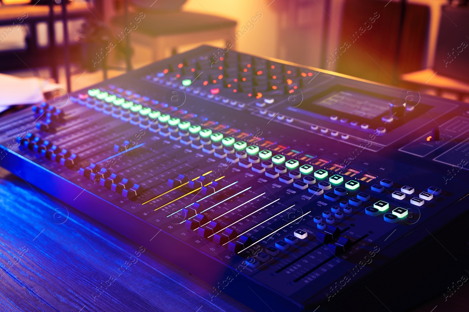 Photo of Professional mixing console on table in radio studio, closeup