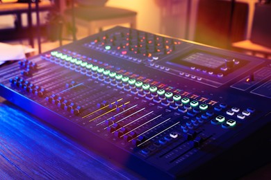 Professional mixing console on table in radio studio, closeup