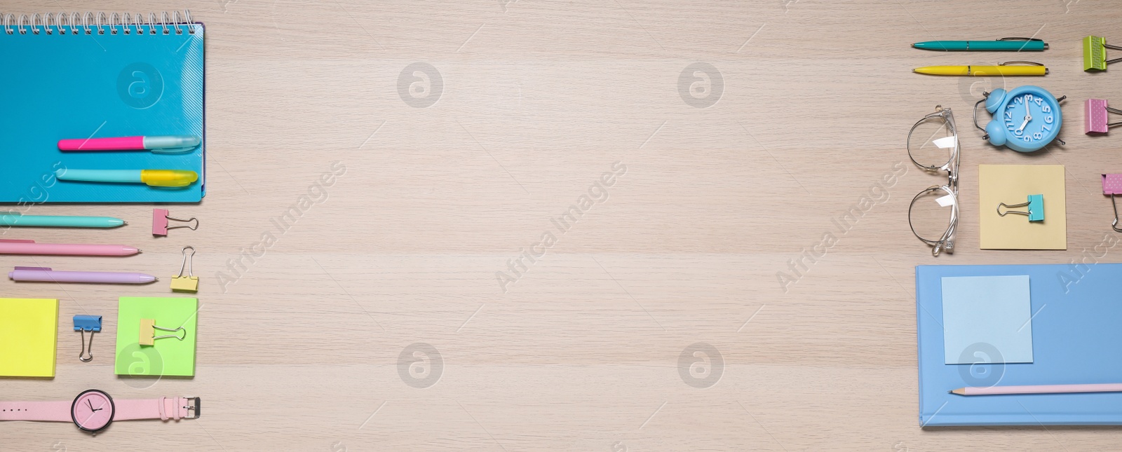 Photo of Different stationery on wooden table, flat lay. Space for text