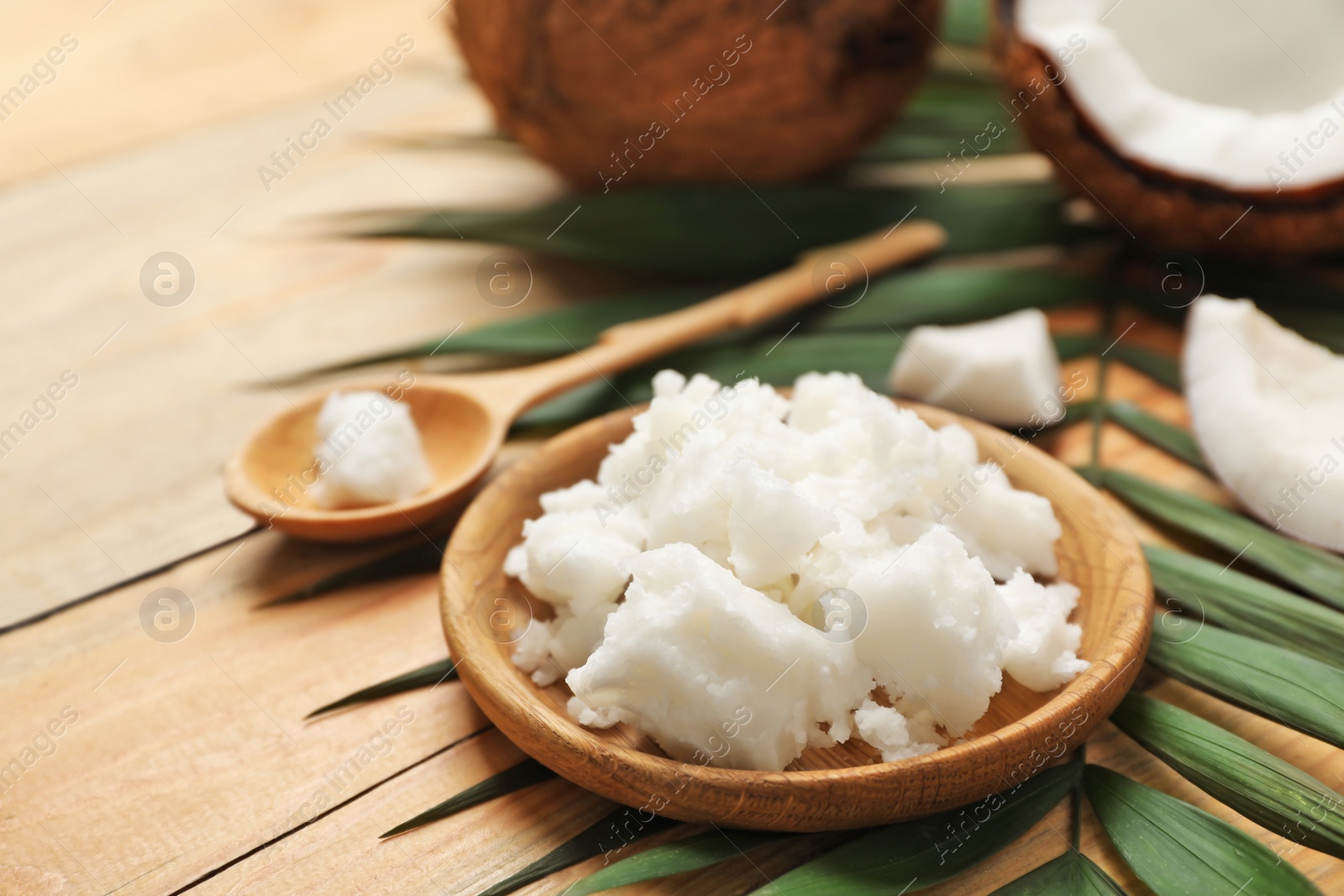 Photo of Plate with coconut oil on table. Healthy cooking