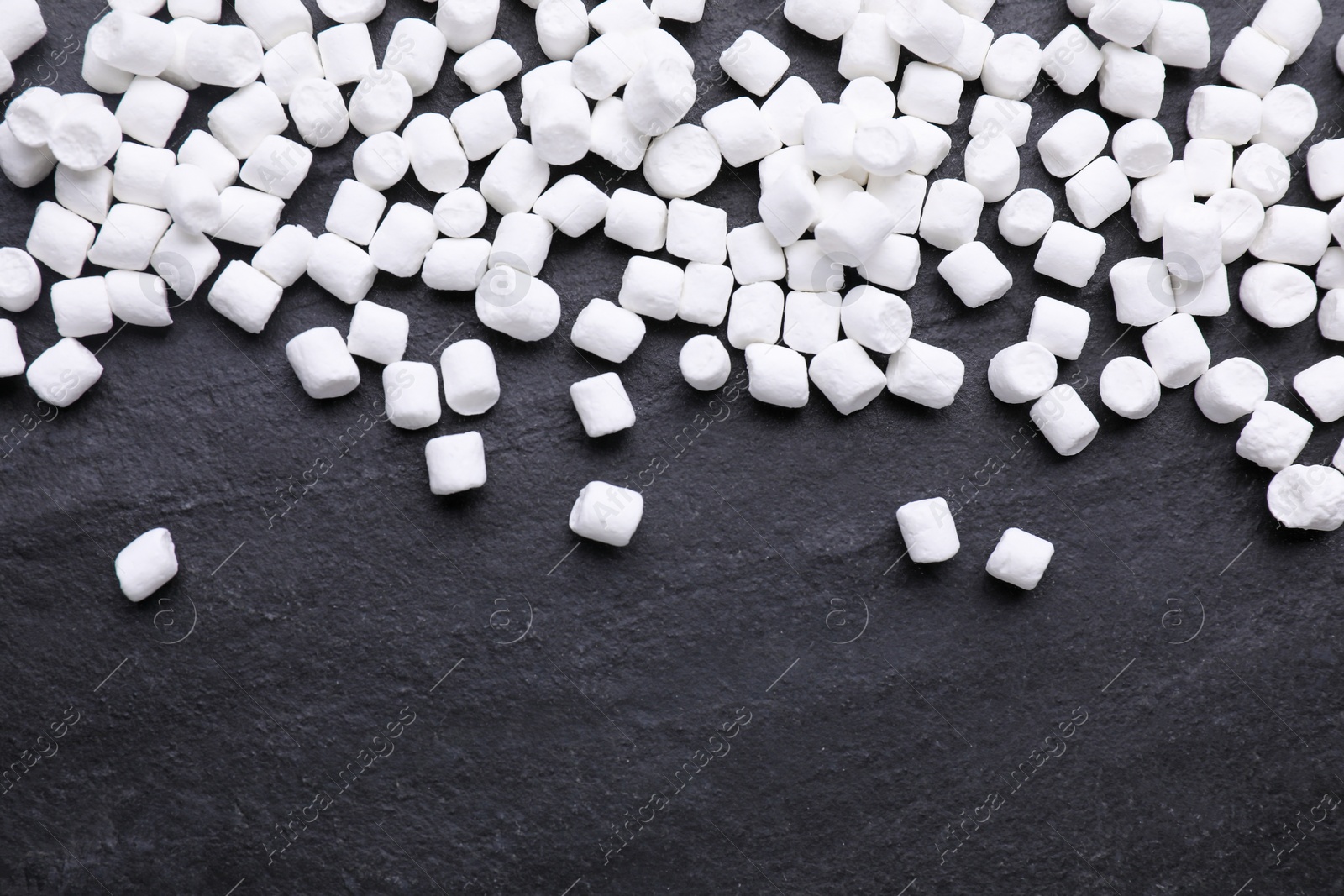 Photo of Delicious marshmallows on black background, flat lay