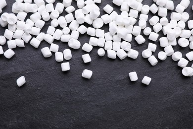 Delicious marshmallows on black background, flat lay