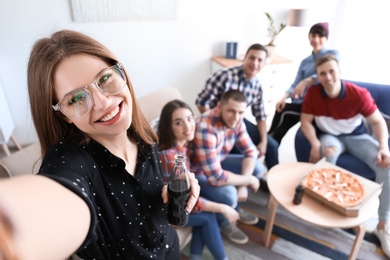 Photo of Happy friends taking selfie indoors