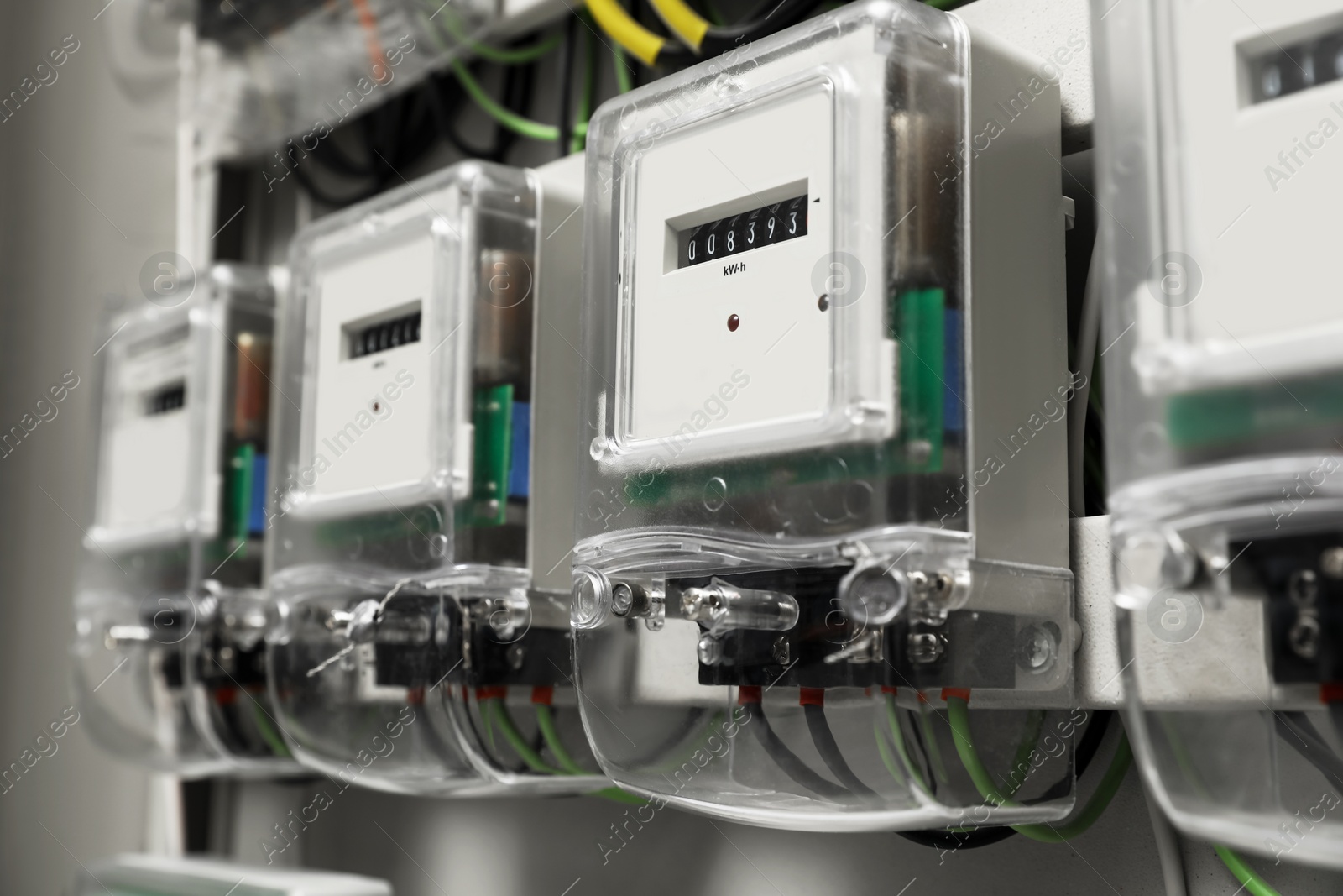 Photo of Electric meters and wires in fuse box, closeup. Space for text