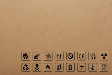 Image of Cardboard box with packaging symbols as background, closeup