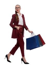 Photo of Stylish young businesswoman with shopping bags on white background