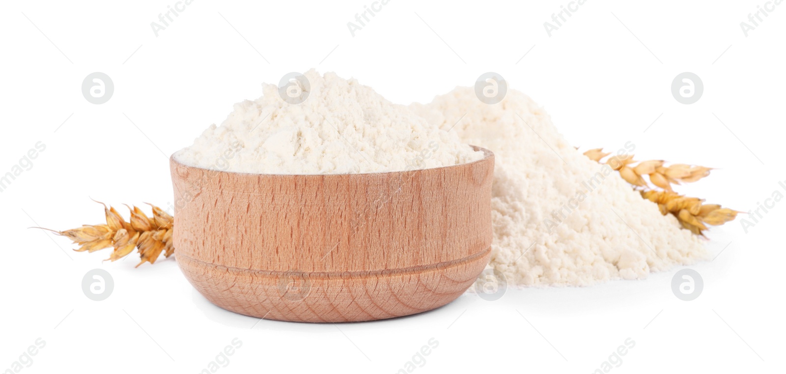 Photo of Wooden bowl with wheat flour on white background