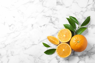 Flat lay composition with ripe oranges and space for text on marble background