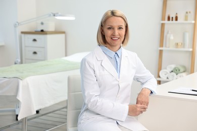 Photo of Portrait of happy dermatologist in modern clinic