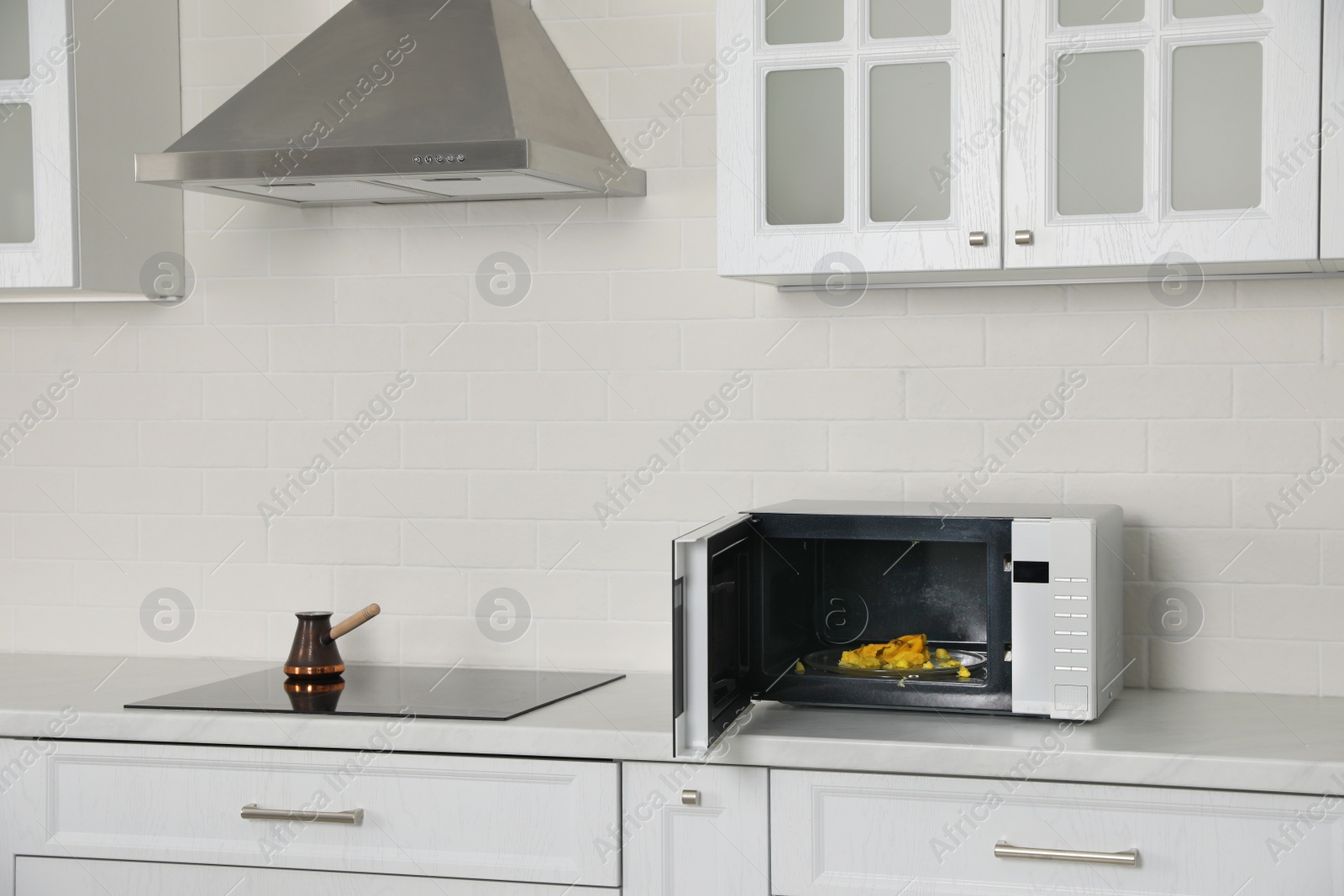 Photo of Dirty microwave oven on countertop in kitchen