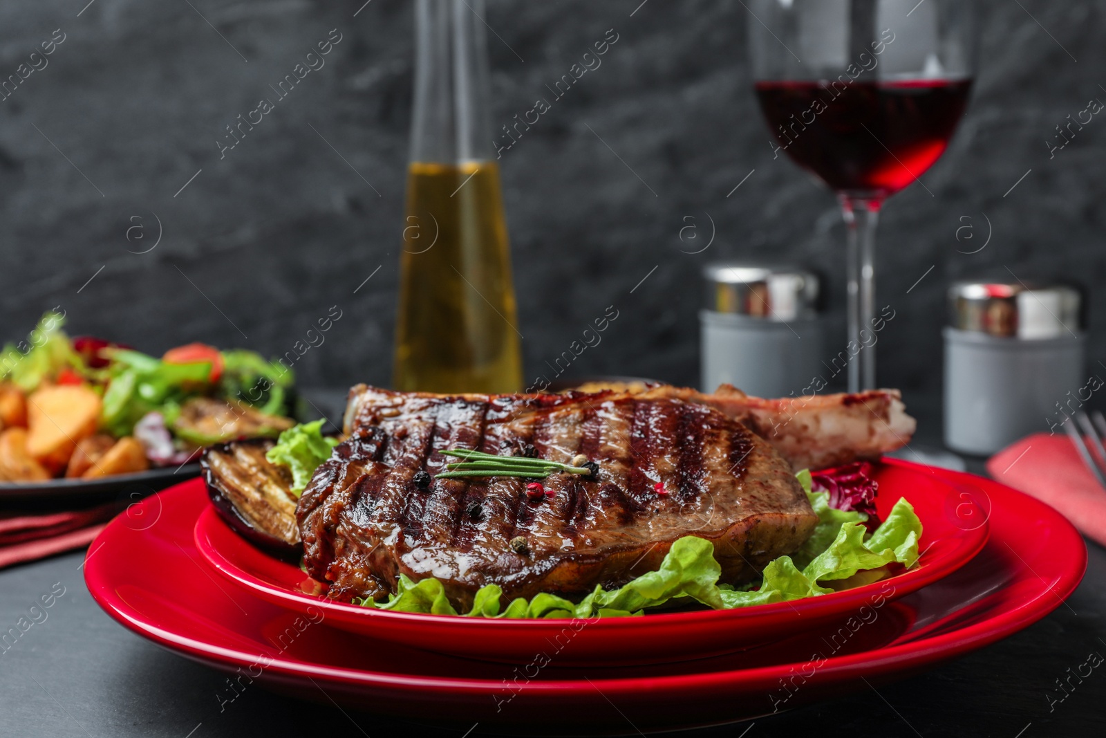 Photo of Delicious beef steak served on grey table, closeup