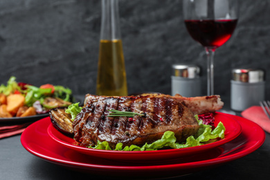 Photo of Delicious beef steak served on grey table, closeup