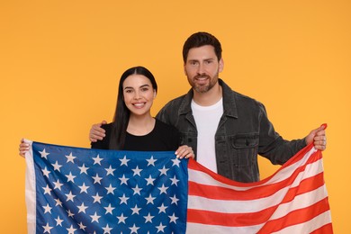 4th of July - Independence Day of USA. Happy couple with American flag on yellow background