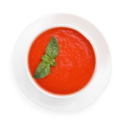 Photo of Delicious tomato soup with basil isolated on white, top view