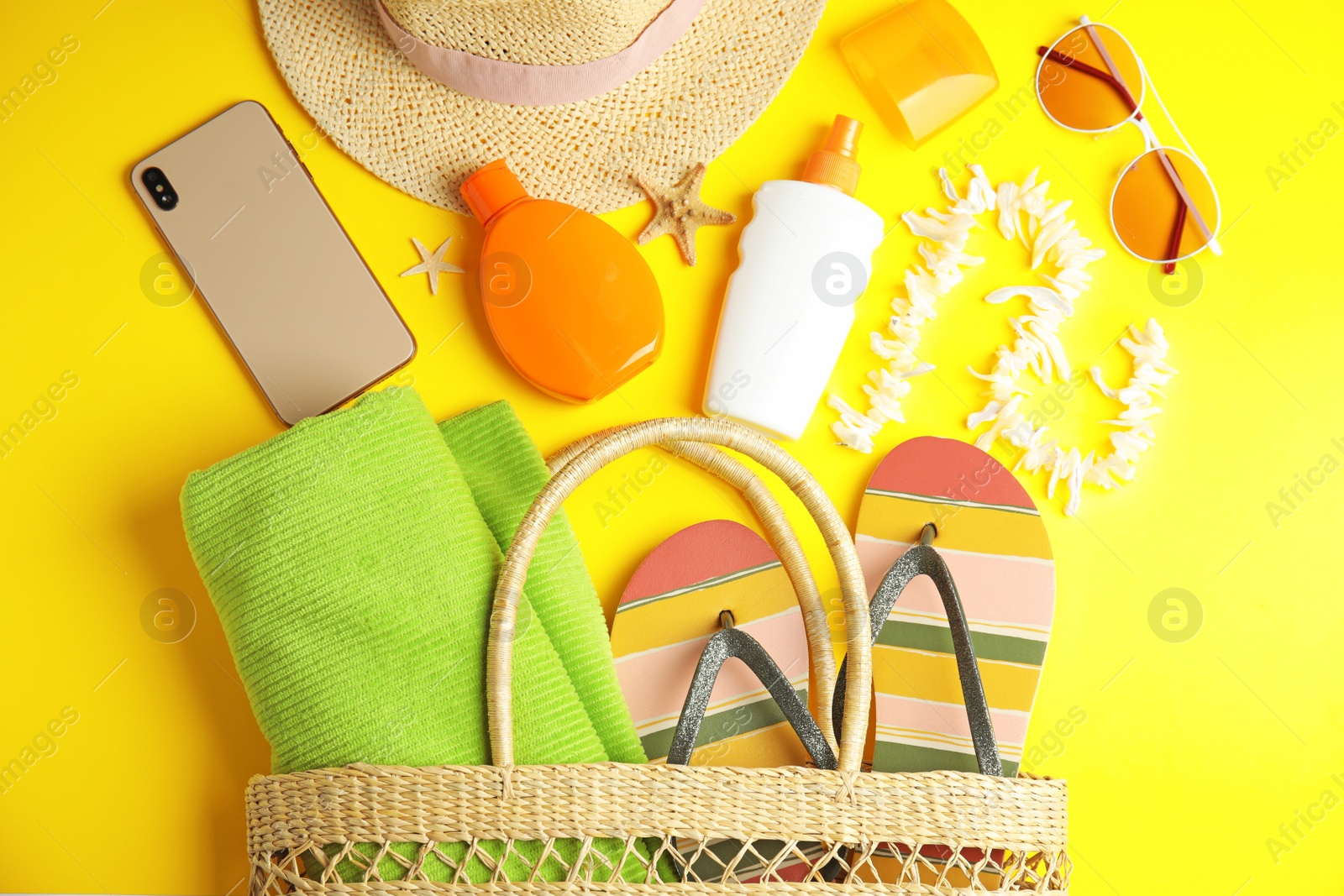 Photo of Flat lay composition with beach objects on yellow background