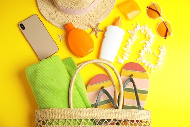 Flat lay composition with beach objects on yellow background