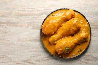 Tasty chicken curry on wooden table, top view. Space for text