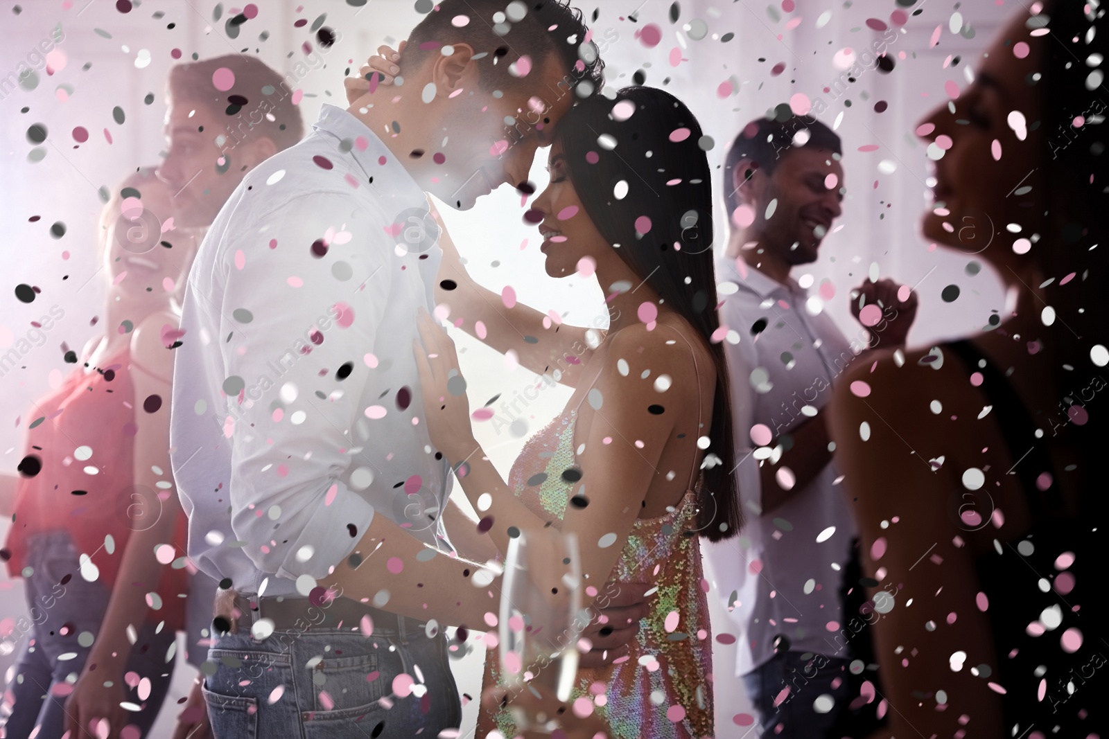 Image of Lovely young couple dancing together at party