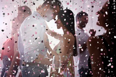 Image of Lovely young couple dancing together at party