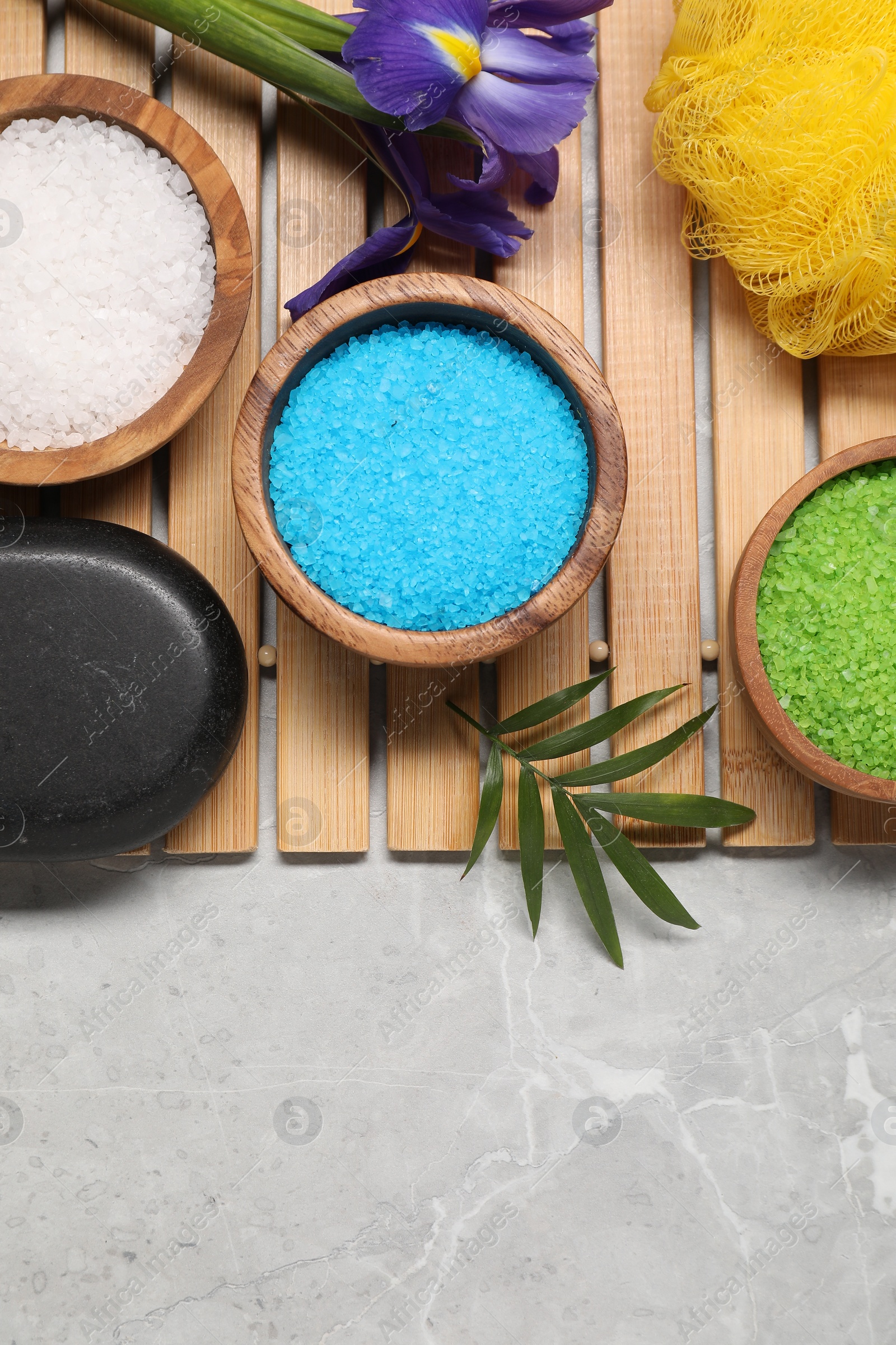 Photo of Flat lay composition with natural sea salt on grey marble table. Space for text