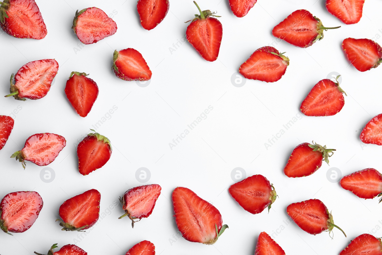 Photo of Halves of delicious ripe strawberries on white background, flat lay. Space for text