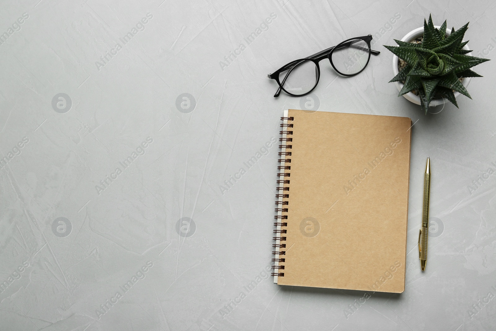 Photo of Flat lay composition with notebook on light textured table. Space for text