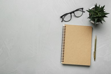 Photo of Flat lay composition with notebook on light textured table. Space for text