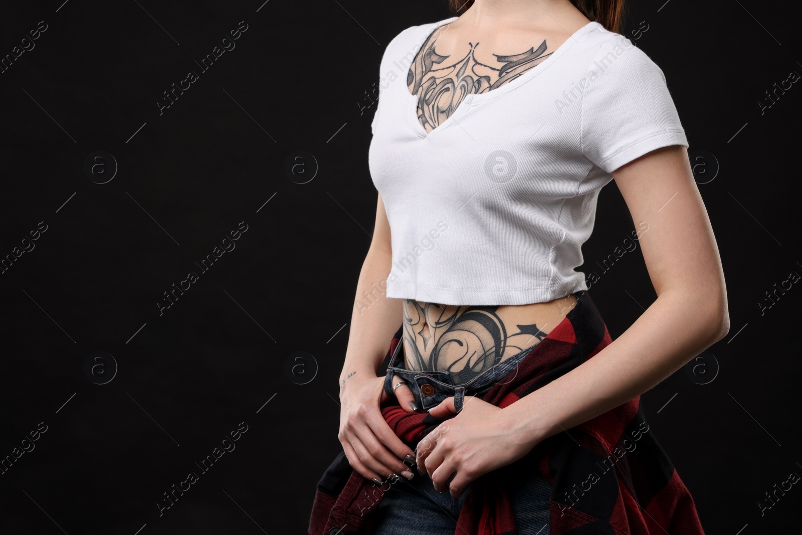 Photo of Woman with cool tattoos on black background, closeup. Space for text