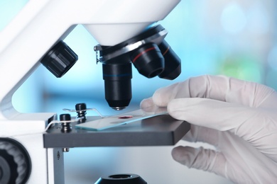 Photo of Analyst doing laboratory test with microscope, closeup. Chemical analysis