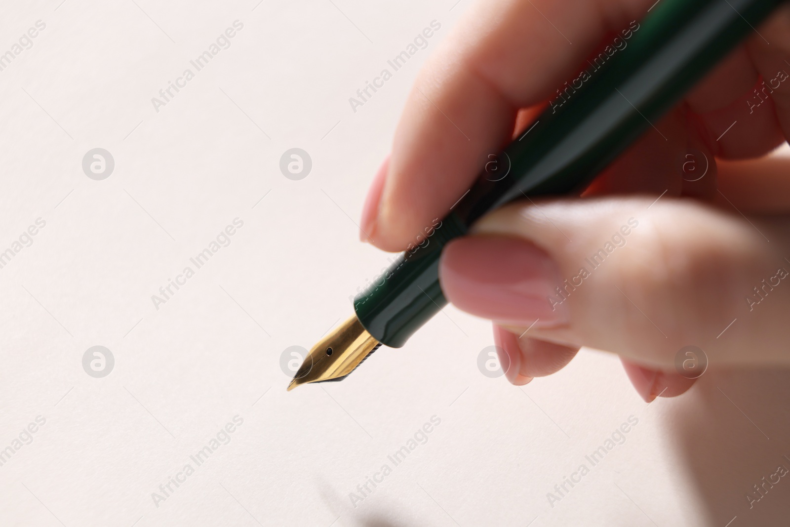 Photo of Woman writing with fountain pen, closeup. Space for text