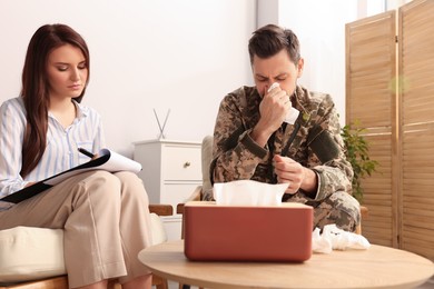 Psychologist working with military officer in office