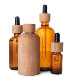 Different bottles of essential oil on white background