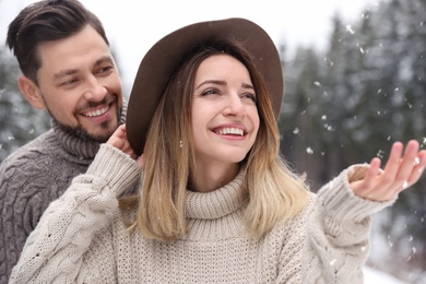 Cute couple outdoors on snowy day. Winter vacation