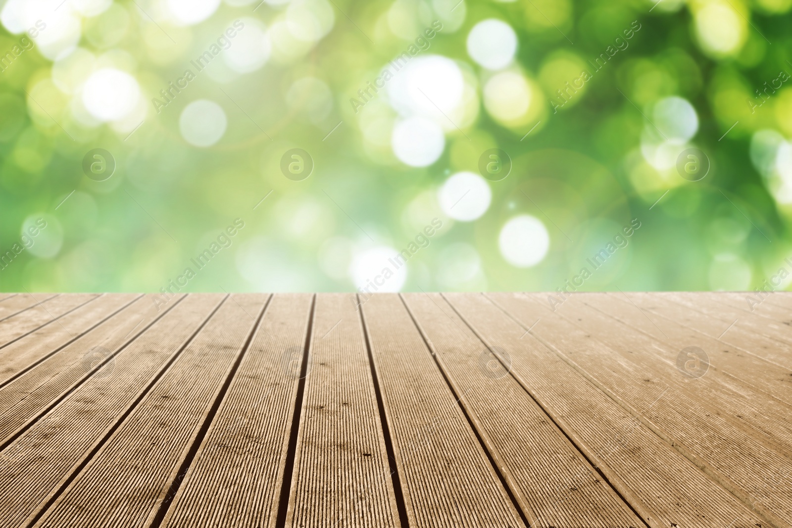 Image of Empty wooden surface against blurred green background. Bokeh effect