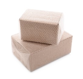 Cardboard boxes packed in bubble wrap on white background