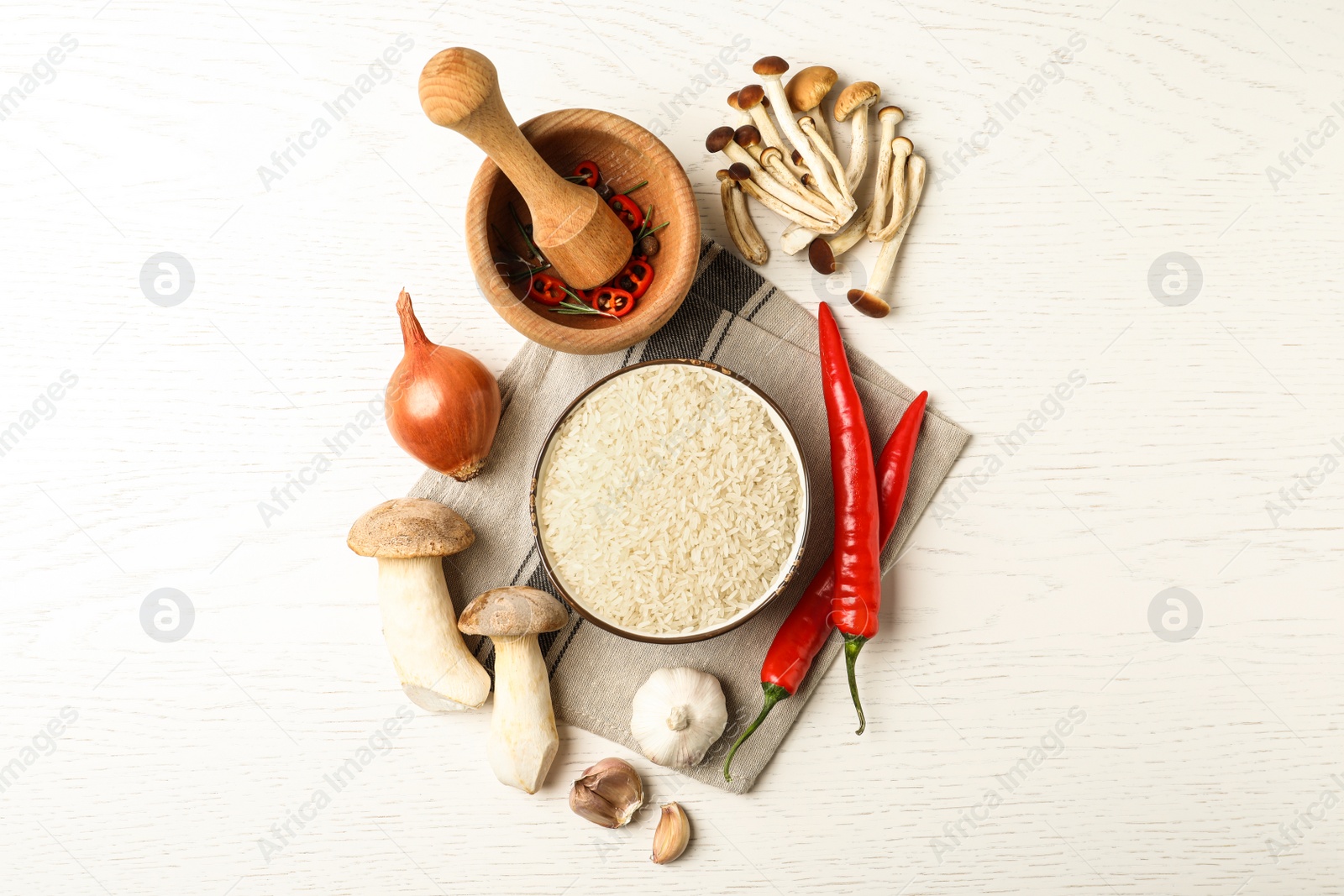 Photo of Flat lay composition with different ingredients on white wooden table. Risotto recipe