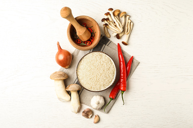 Photo of Flat lay composition with different ingredients on white wooden table. Risotto recipe