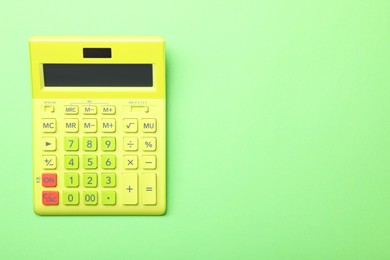 Photo of Calculator on green background, top view with space for text. Tax accounting concept