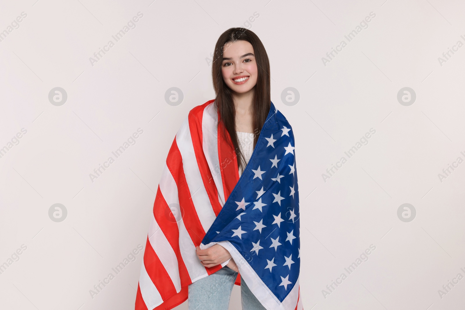 Photo of 4th of July - Independence Day of USA. Happy girl with American flag on white background