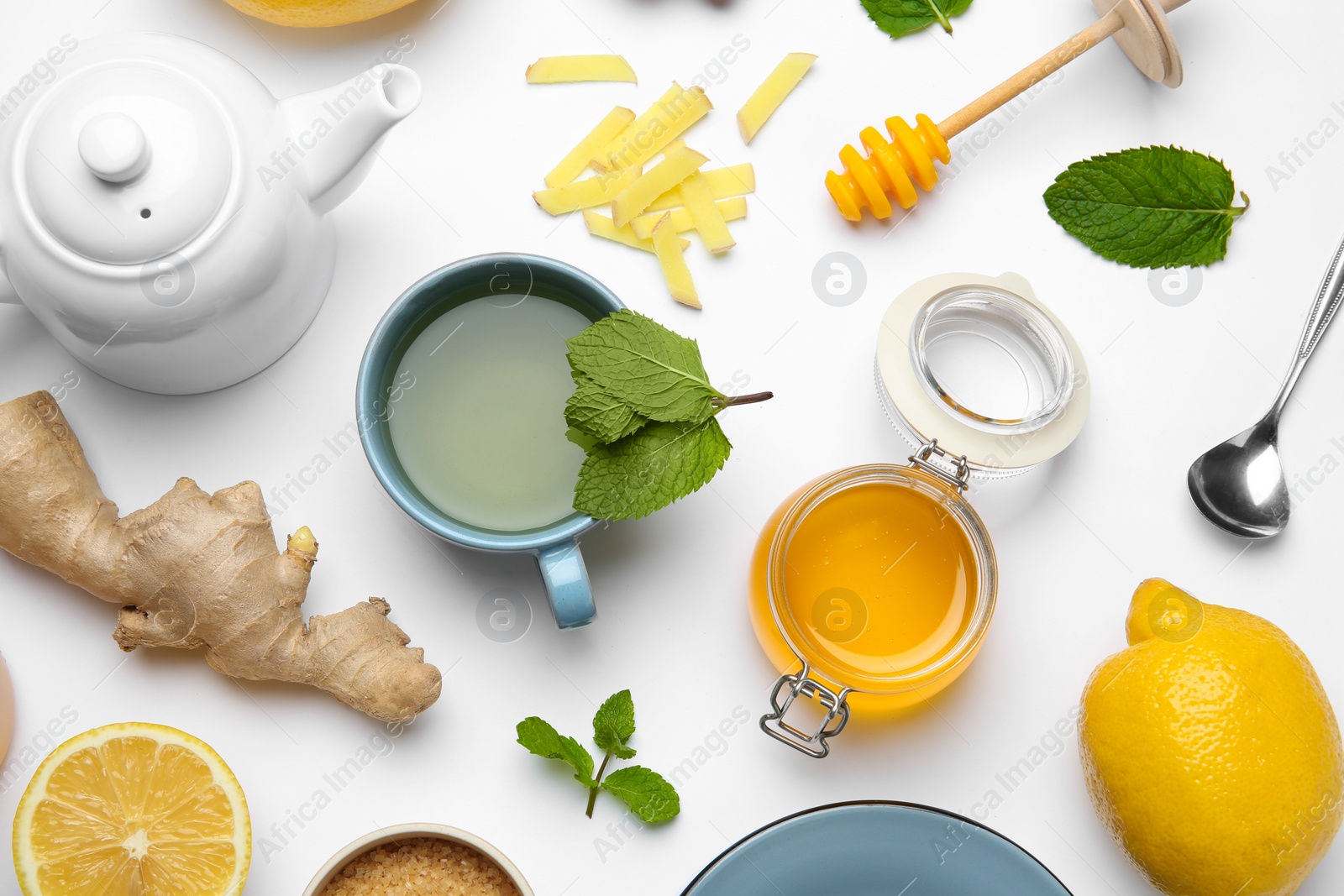 Photo of Composition with lemon tea, honey and ginger on white background, top view