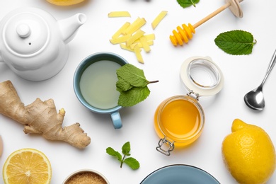 Photo of Composition with lemon tea, honey and ginger on white background, top view