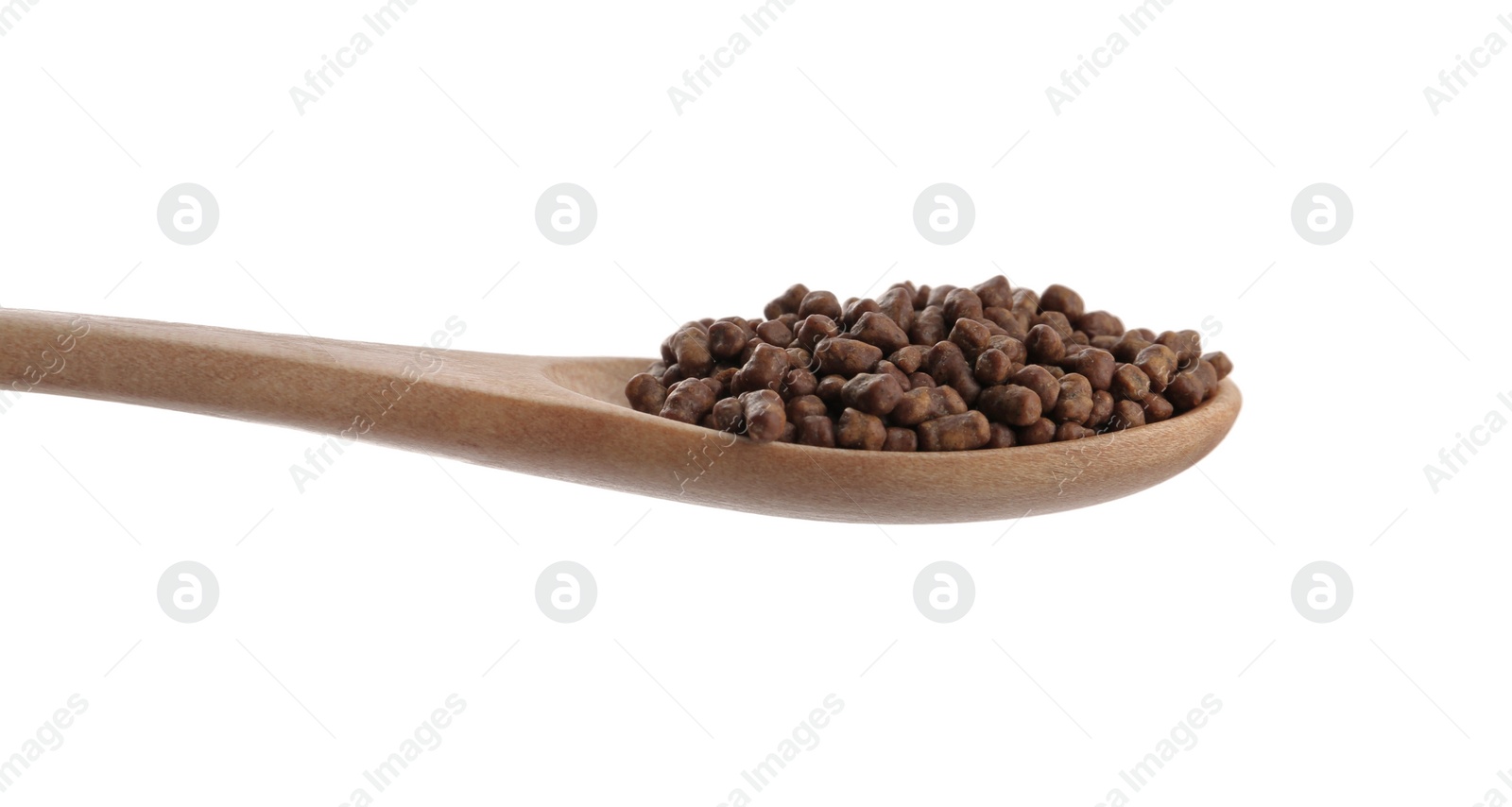 Photo of Buckwheat tea granules in wooden spoon on white background