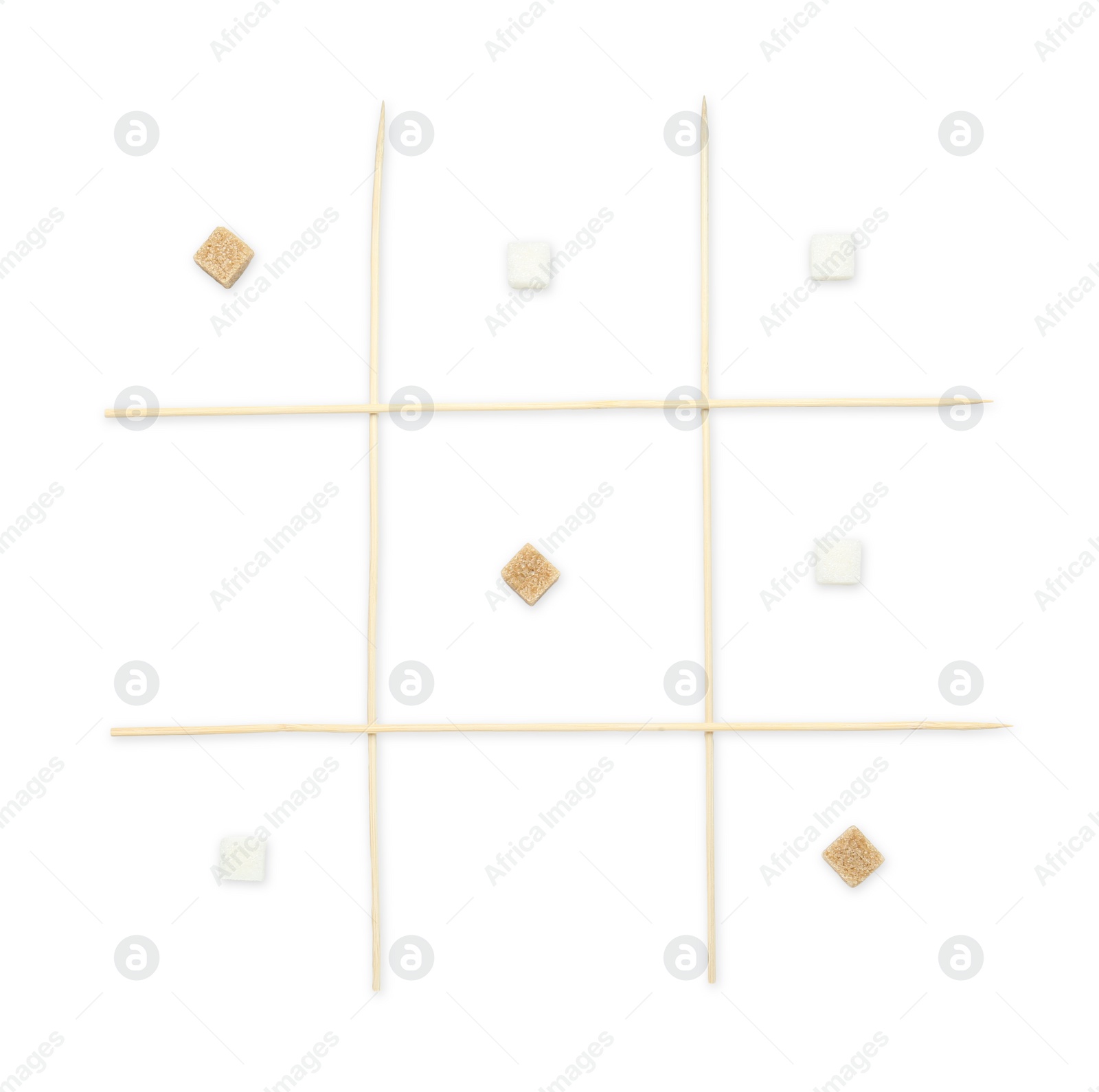 Photo of Tic tac toe game made with sugar cubes isolated on white, top view