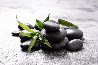 Photo of Spa stones and bamboo sprout on grey table