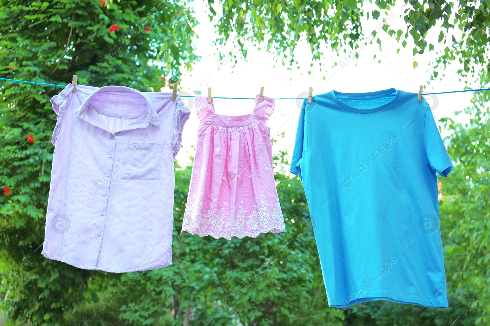 Photo of Clothes on laundry line outdoors on sunny day