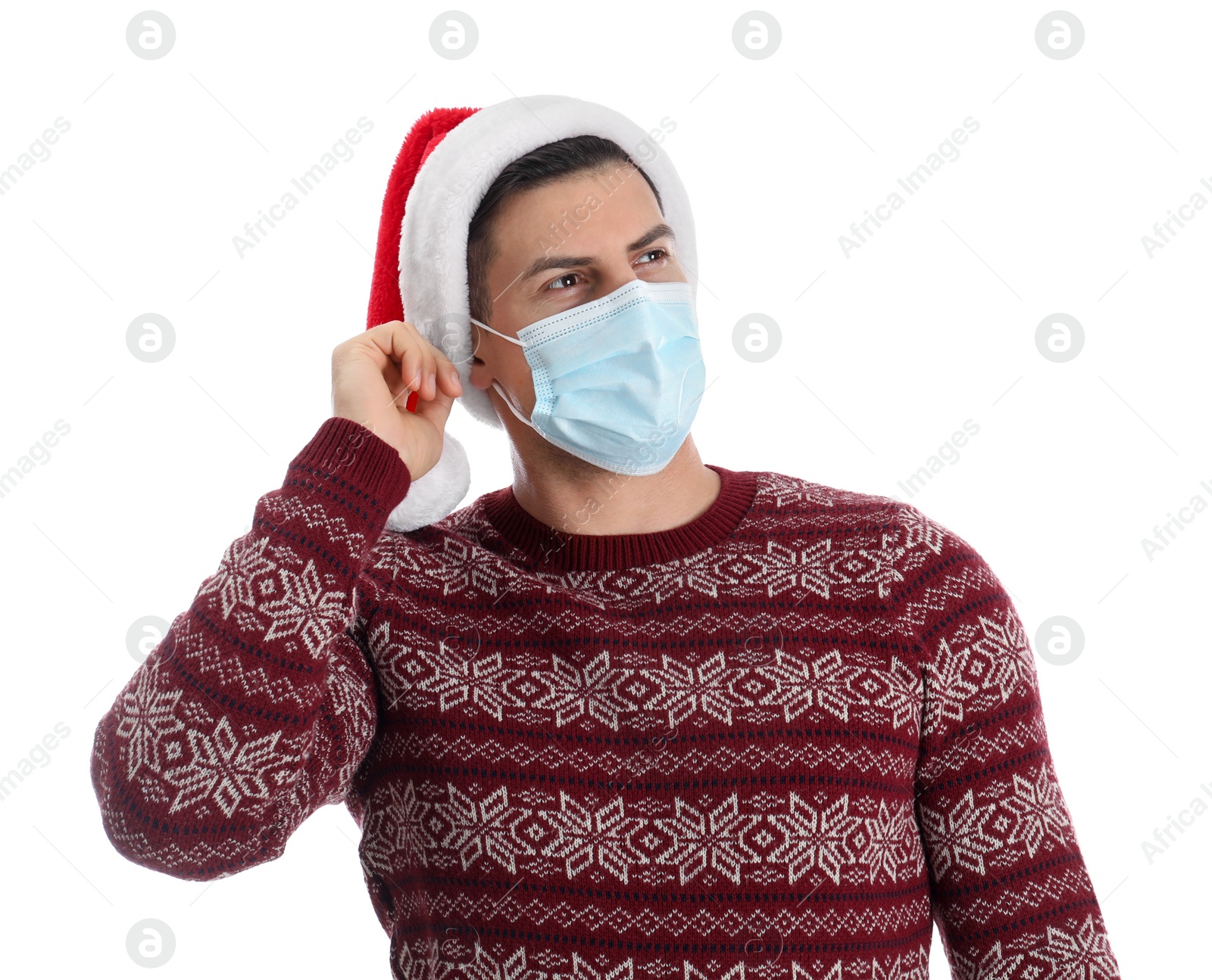 Photo of Man wearing Santa hat and medical mask on white background