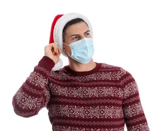 Man wearing Santa hat and medical mask on white background