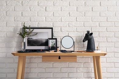 Dressing table with mirror, makeup products and accessories in room